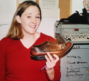 Tiffany Lankes stands with the famous Shoe in front of the filing cabinet signed by former EICs located in the management office at 744 Ostrom Ave. during her tenure at The Daily Orange in the early 2000s.