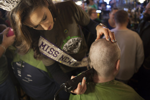 The 14th annual St. Baldrick’s fundraiser event took place at Kitty Hoynes Irish Pub on Sunday, where Miss New York International Lexi Kerr volunteered to help shave heads to raise money for childhood cancer research.