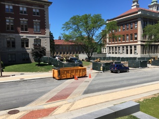 Temporary fences and other construction equipment have been set up between Slocum Hall and Lyman Hall for various projects that will be completed over the summer. Photo taken June 15, 2016